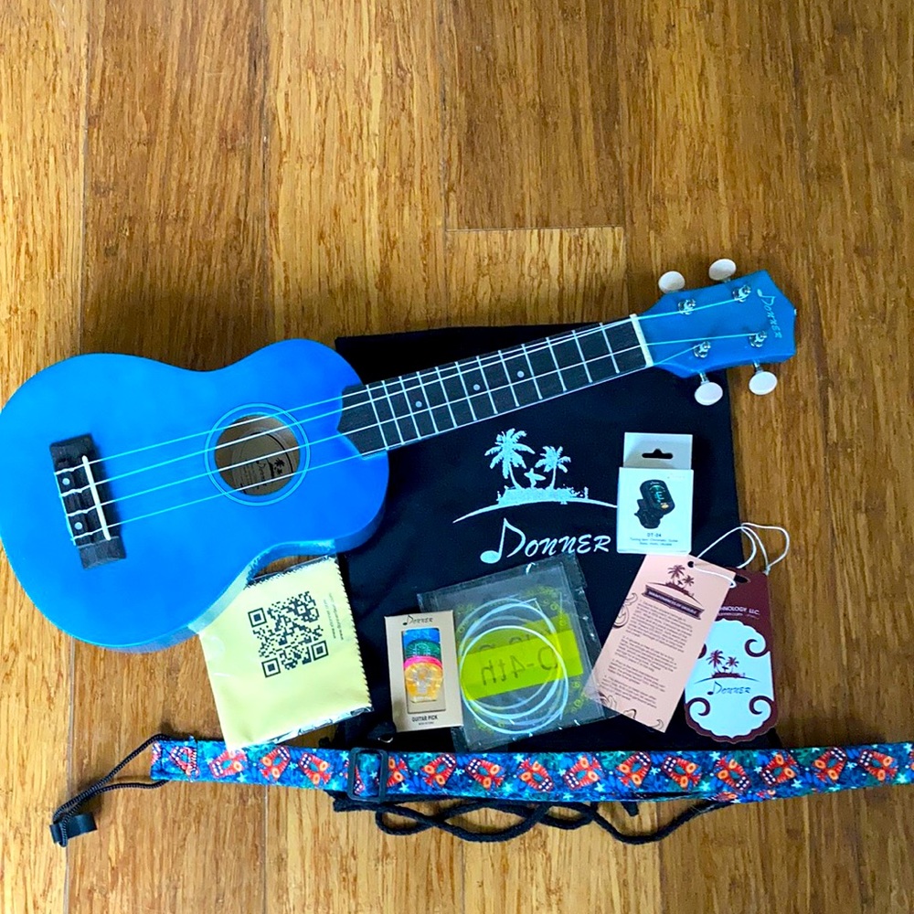 Blue ukulele with accessories. Donner brand.